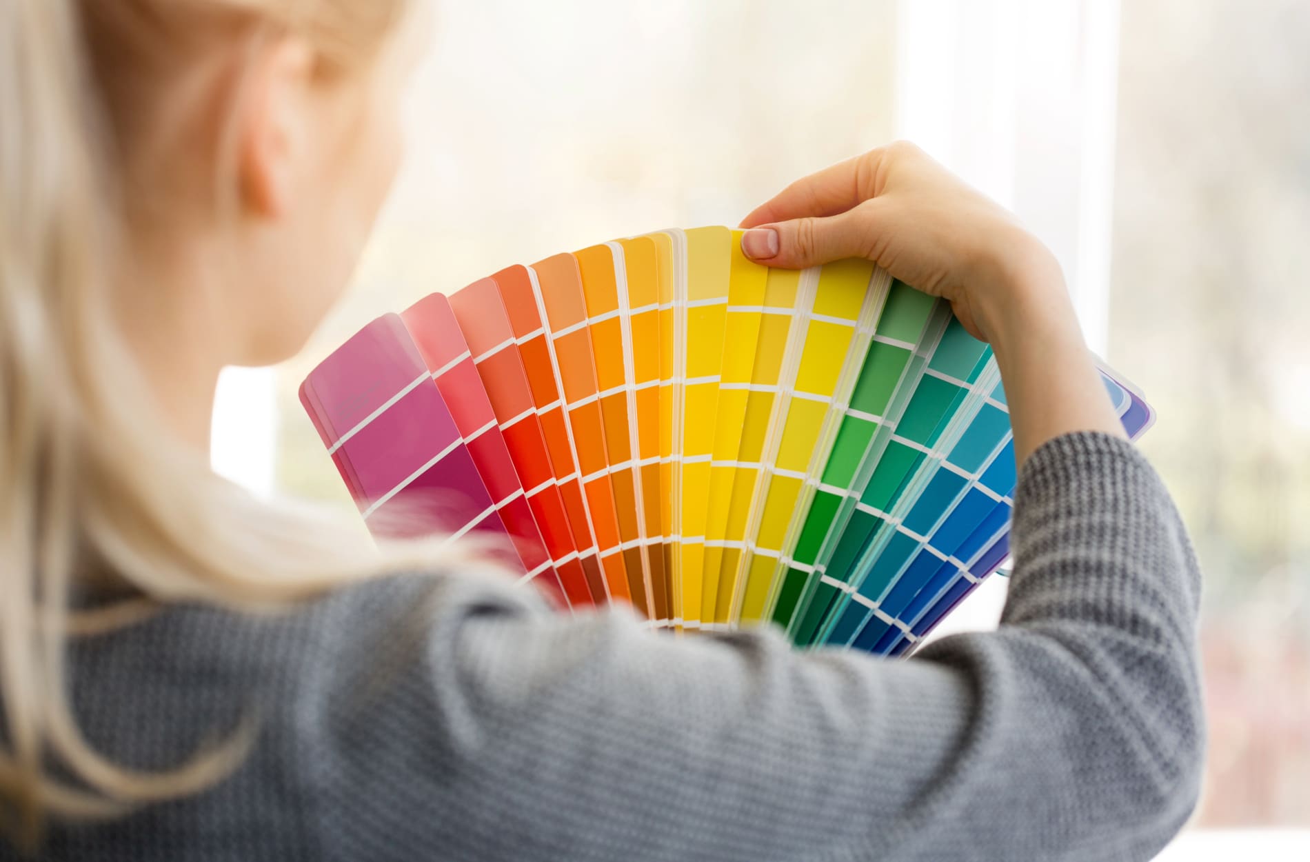 woman choosing the right paint color for her home painting job