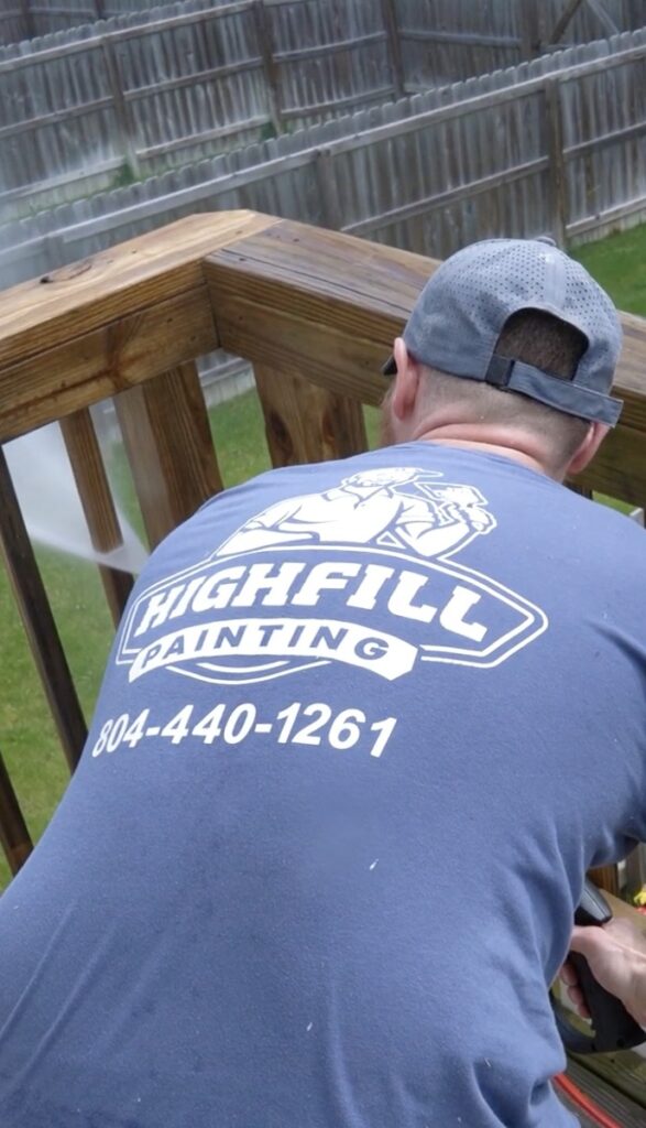 Worker powerwashing deck in Richmond, VA