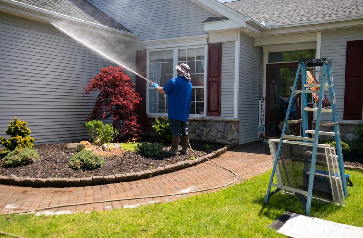 Worker pressure washing a home in Richmond, VA