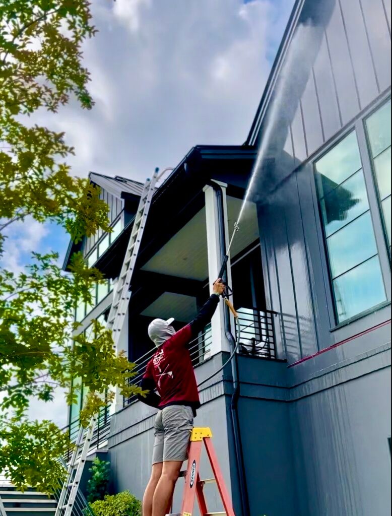 Worker pressure washing a home in Richmond, VA