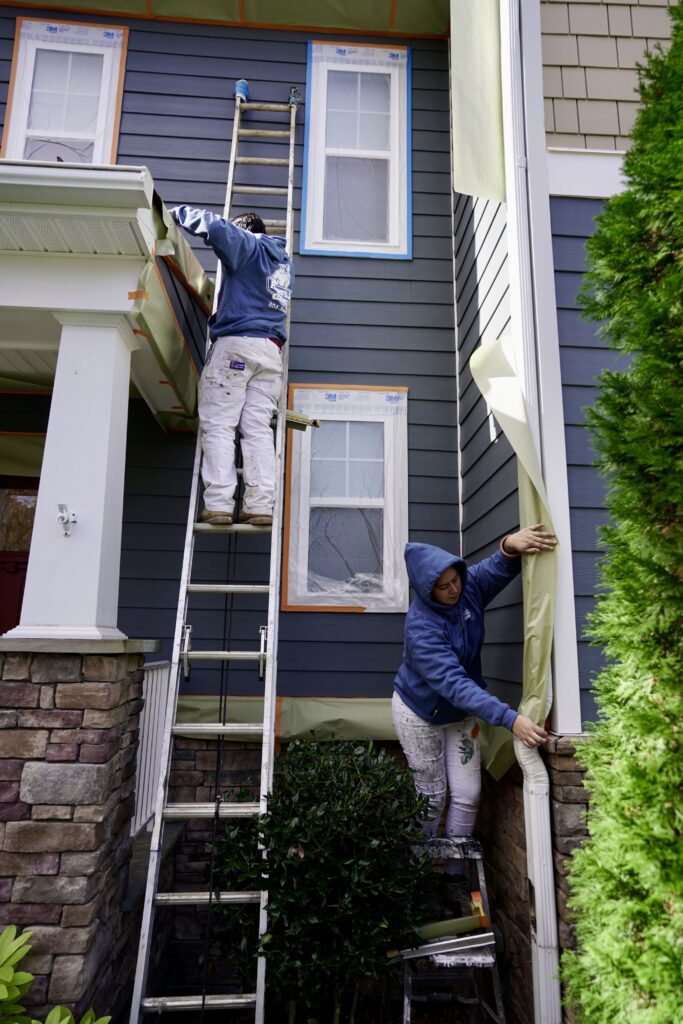Highfill workers painting the outside of a home in Richmond, VA.