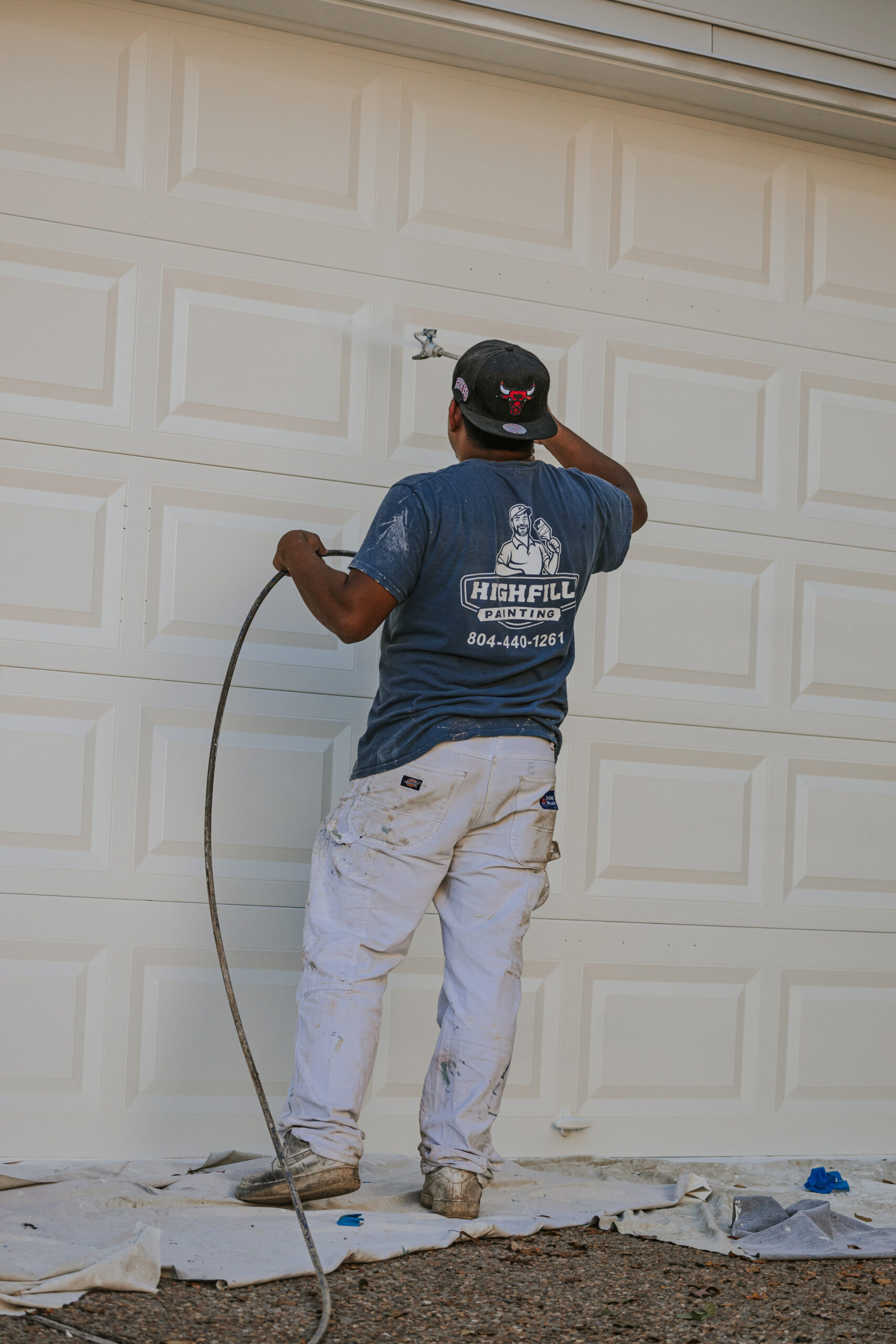 Highfill worker painting the outside of a home in Richmond, VA.
