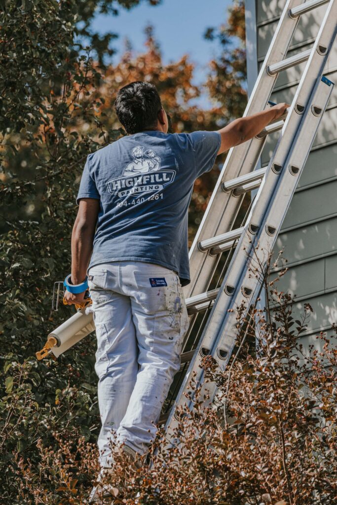 Highfill worker painting the outside of a home in Richmond, VA.