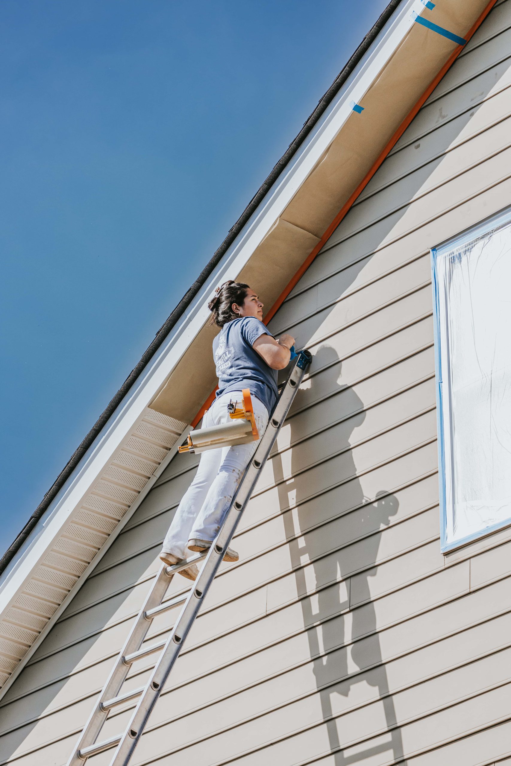 Highfill worker painting the outside of a home in Richmond, VA.