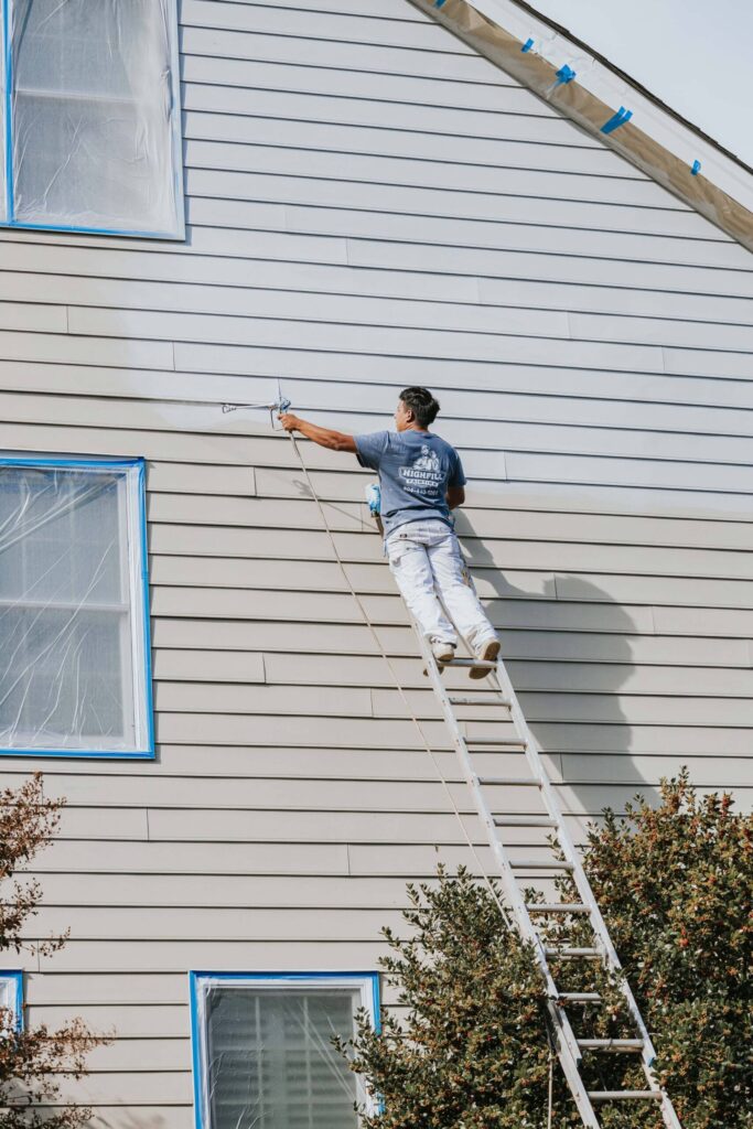 Highfill worker painting the outside of a home in Richmond, VA.