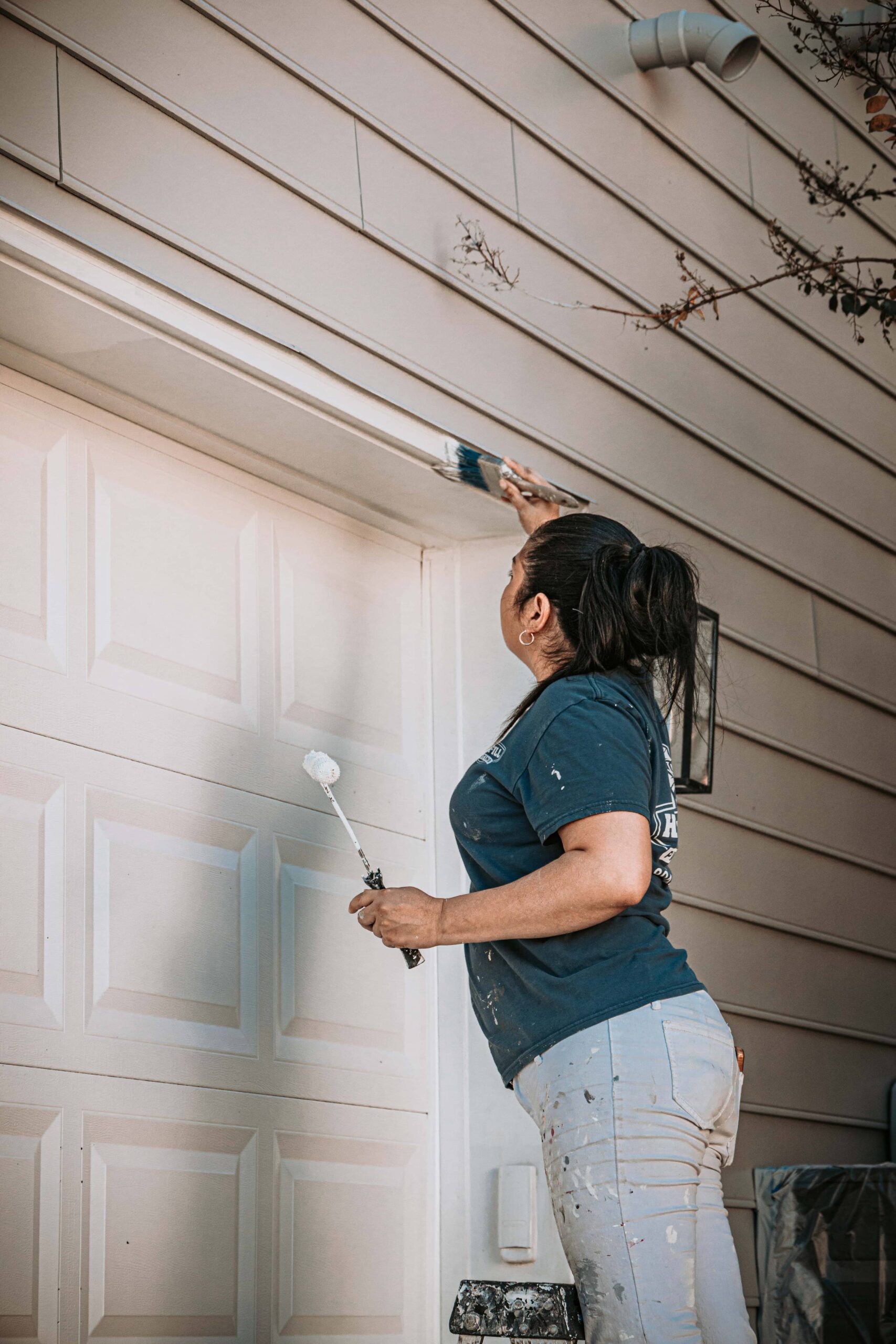 Highfill worker painting the outside of a home in Richmond, VA.